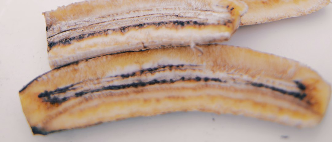 Halved bananas laid out in rows, drying